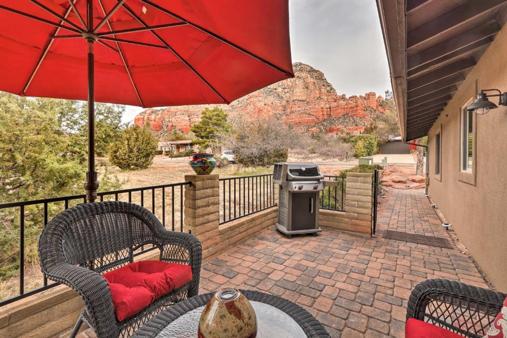 a patio with a table and chairs and an umbrella at Sedona Casita on Thunder Mountain Walk to Trails in Sedona