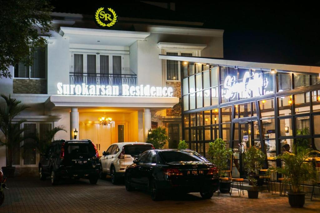 a building with cars parked in front of it at night at Surokarsan Residence in Yogyakarta
