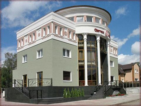 a large white building with a round top at Villa Glamour in Kaliningrad