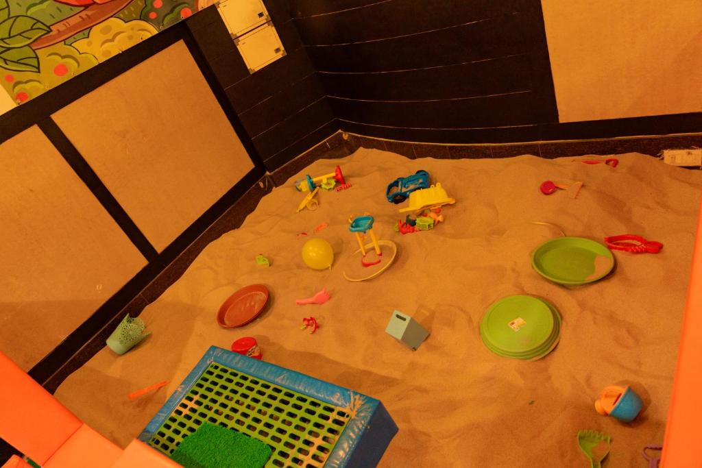 a pile of toys on the floor in a room at Pallavi West in Panchkula