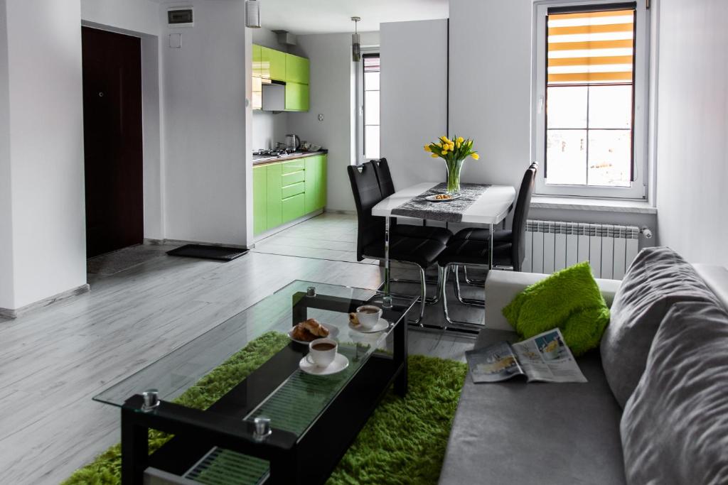 a living room with a couch and a table at Apartament Szczęśliwy in Ustrzyki Dolne