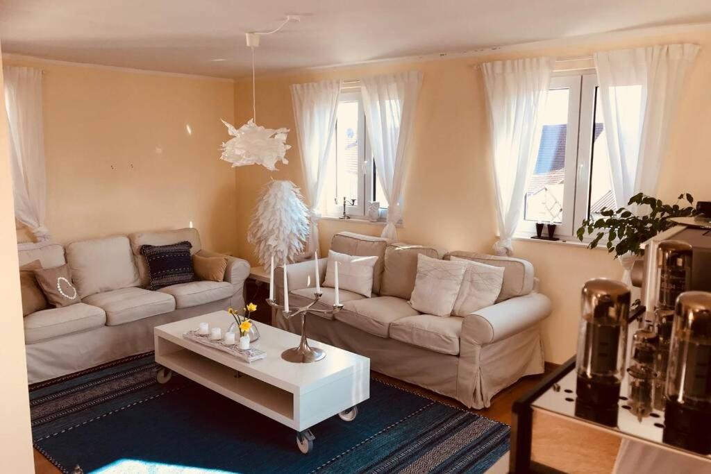 a living room with two couches and a coffee table at Geschmackvoll eingerichtetes Haus in Rauhenebrach