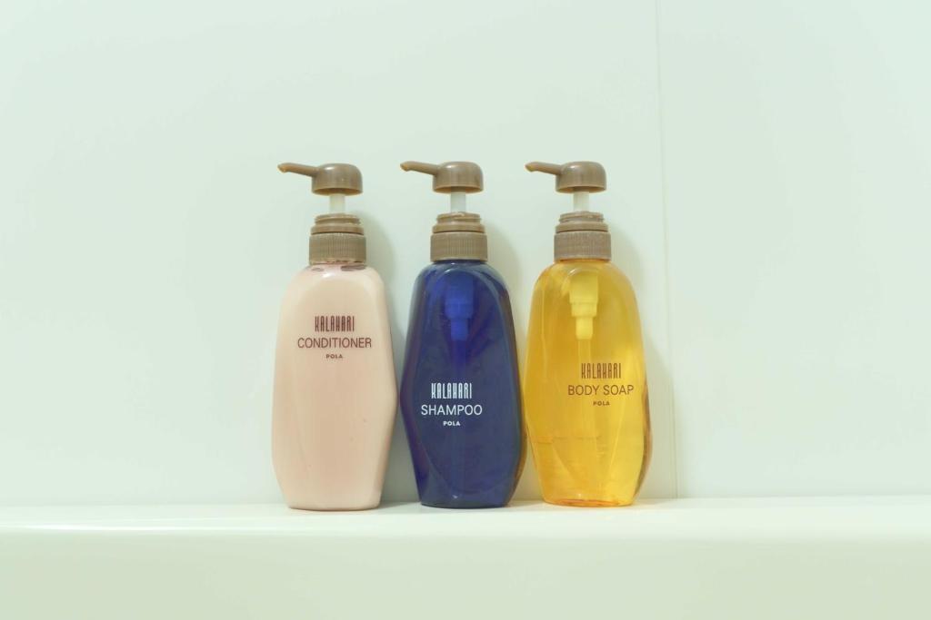a group of three bottles sitting on a shelf at Meitetsu Inn Hamamatsucho in Tokyo