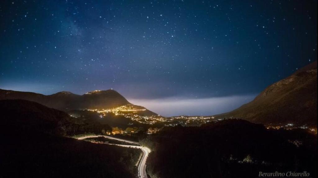 a nightime view of a mountain valley with a road at B&B Terra Mare in Trecchina