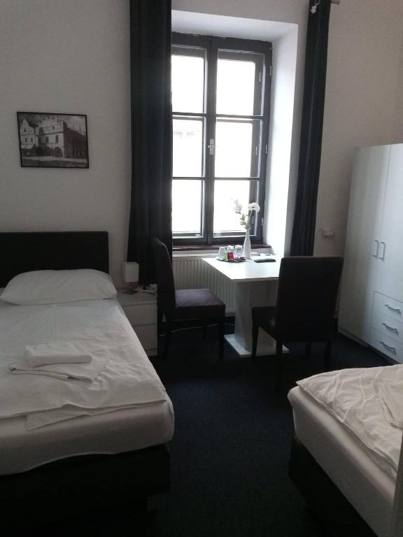 Postel nebo postele na pokoji v ubytování Hotel Bílý Koníček