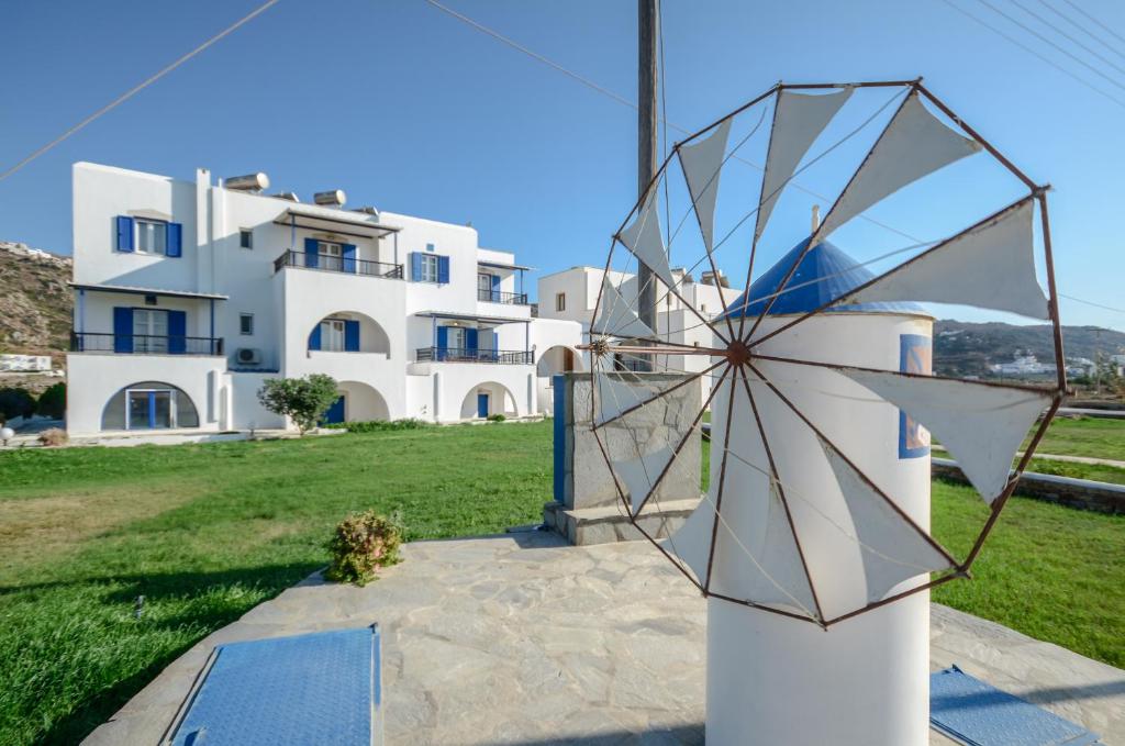 a wind turbine in front of a house at Gaitani apartments plaka naxos in Mikri Vigla