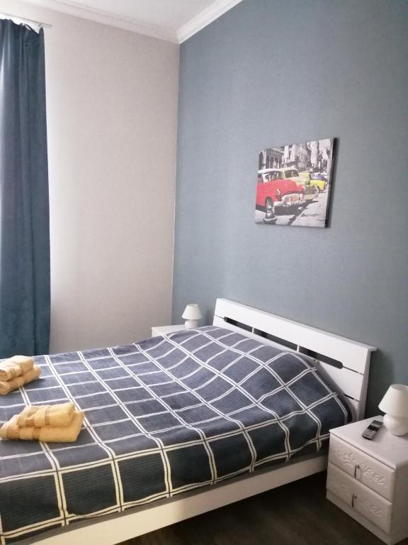 a bedroom with a bed and a red bus on the wall at Apartmen28juni in Chernivtsi