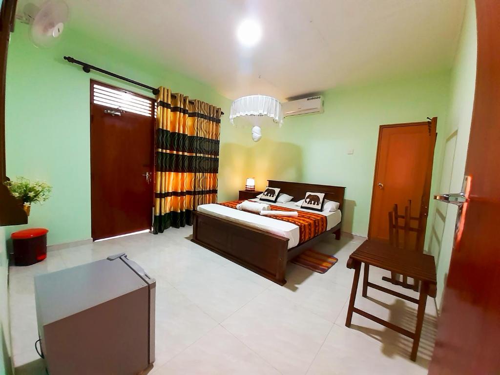 a bedroom with a bed and a tv in it at Stream View Family Resort in Dambulla