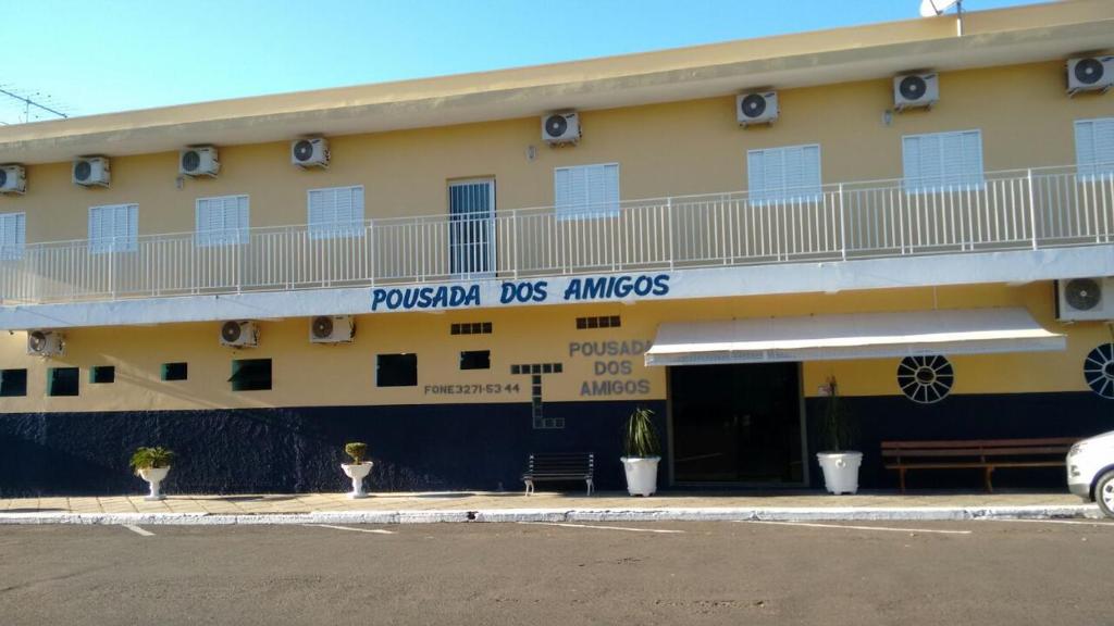 a yellow building with a sign that reads propulsion dos amigos at POUSADA DOS AMIGOS in Presidente Venceslau
