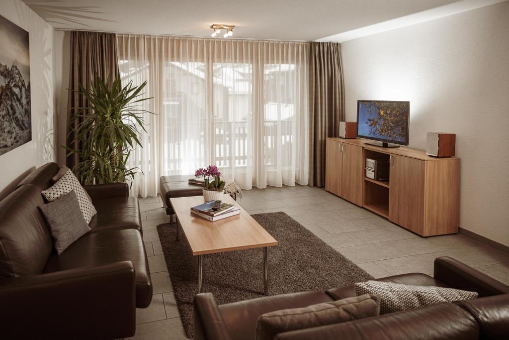 a living room with a couch and a coffee table at Haus Mischabel in Zermatt