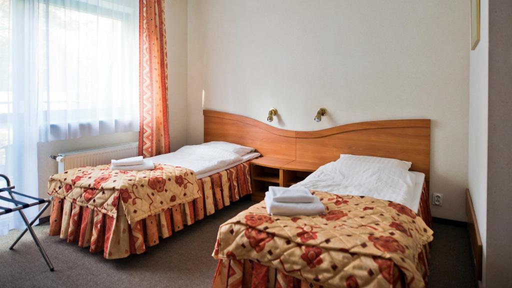 Posteľ alebo postele v izbe v ubytovaní Hotel Kama Park
