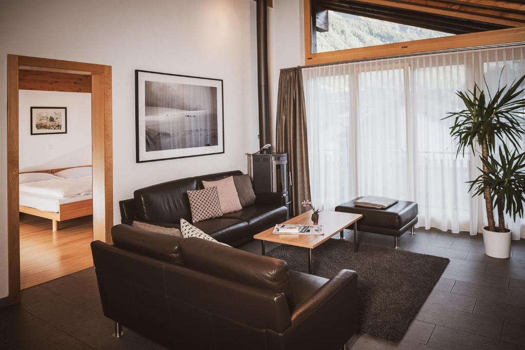 a living room with a couch and a table at Haus Mischabel in Zermatt