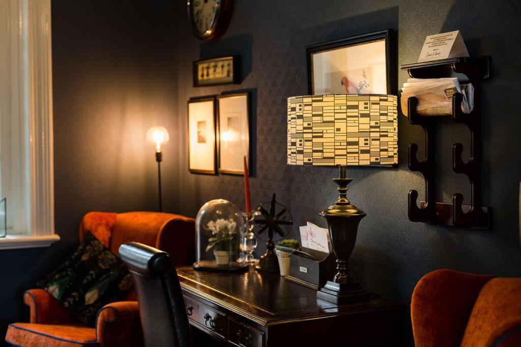 a living room with a desk and a chair at Beachlands Hotel in Weston-super-Mare