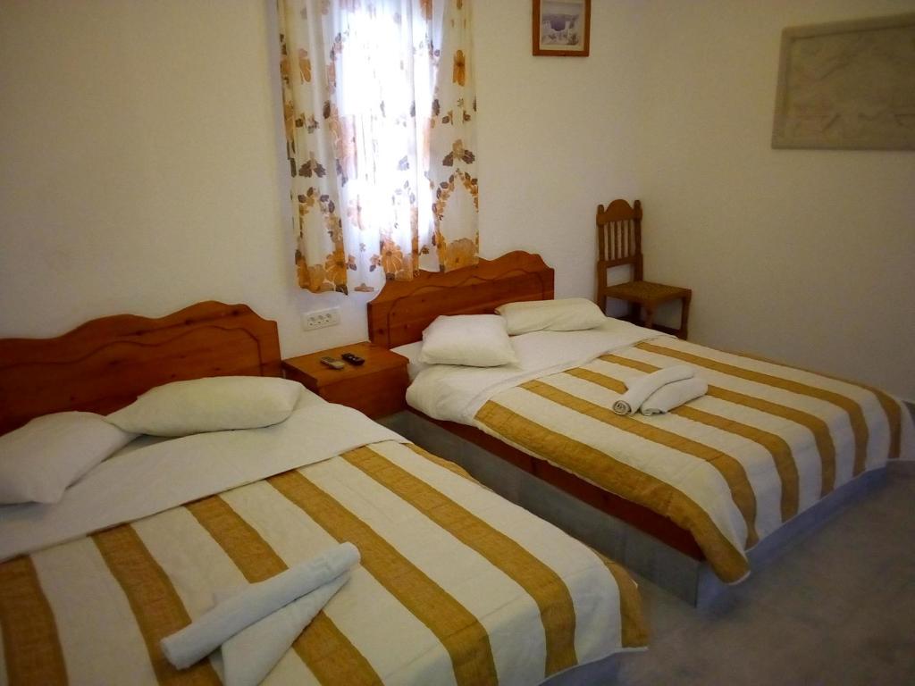 Una cama o camas en una habitación de Hotel Perissa