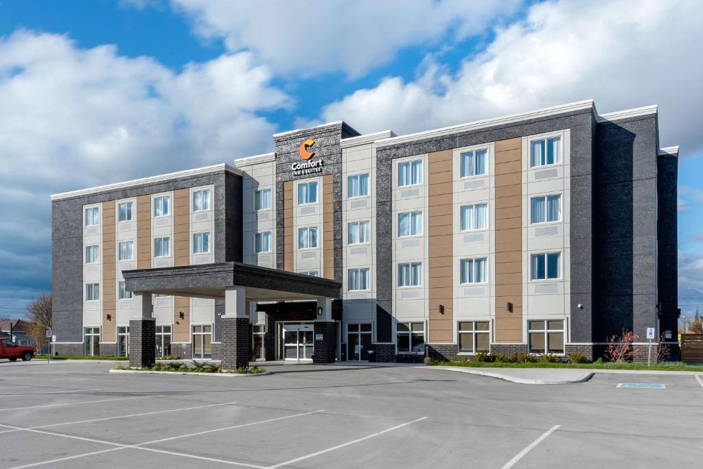 a hotel with a parking lot in front of it at Comfort Inn & Suites in Goderich