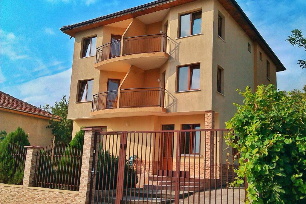 a building with a fence in front of it at Tatyana Guest House in Byala