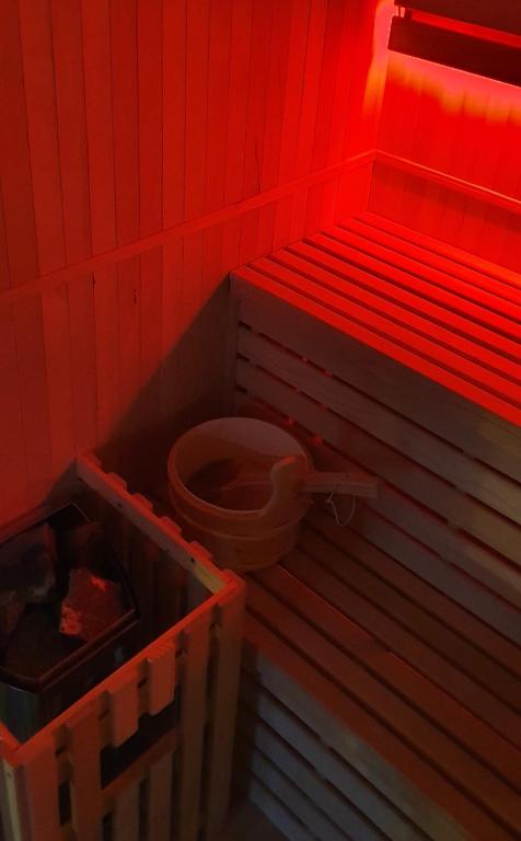 a bathroom with a toilet in a red room at Loft 47 Spa in Chambly