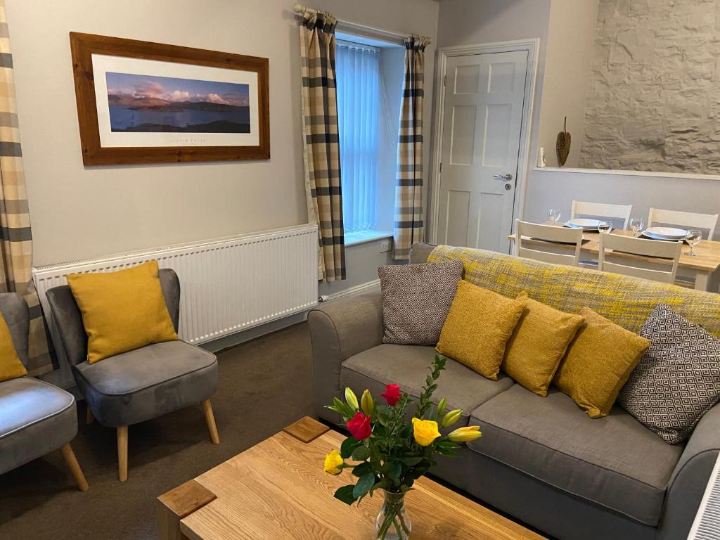 a living room with a couch and chairs and a table at Brampton Holiday Homes - The Mews Apartment in Brampton