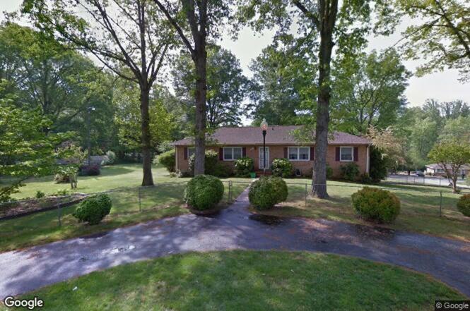 a house with trees and a yard with a driveway at Caribbean Comfort Zone in Chesterfield