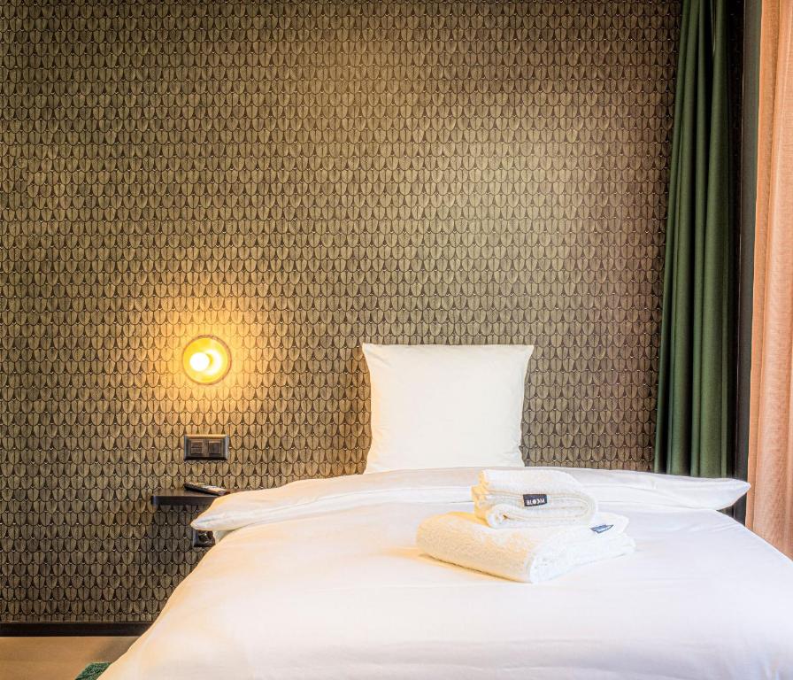 Postel nebo postele na pokoji v ubytování BLOOM Boutique Hotel & Lounge Basel