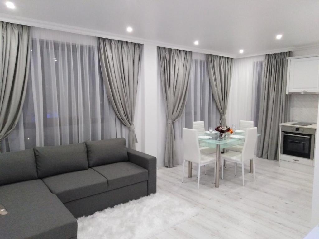 a living room with a couch and a table at Vip Luxury APARTMENT in Burgas City