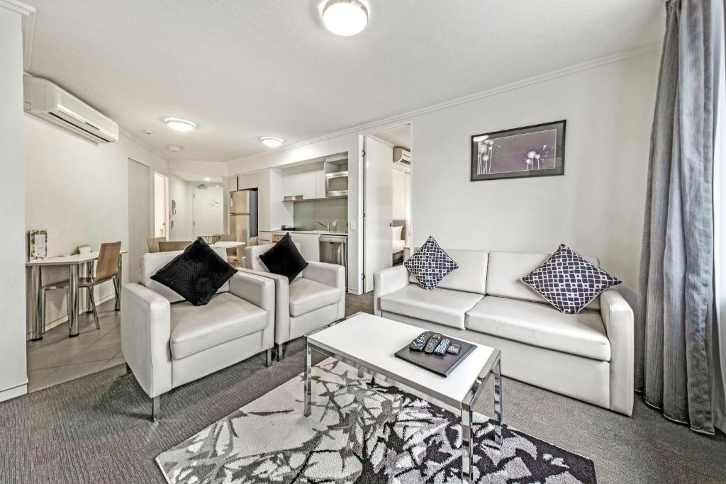 a living room with two couches and a table at The Capitol Apartments in Brisbane