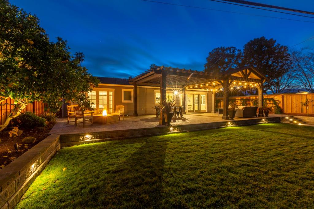 a backyard at night with lights on the grass at @ Marbella Lane Executive Waterfront Property in San Mateo