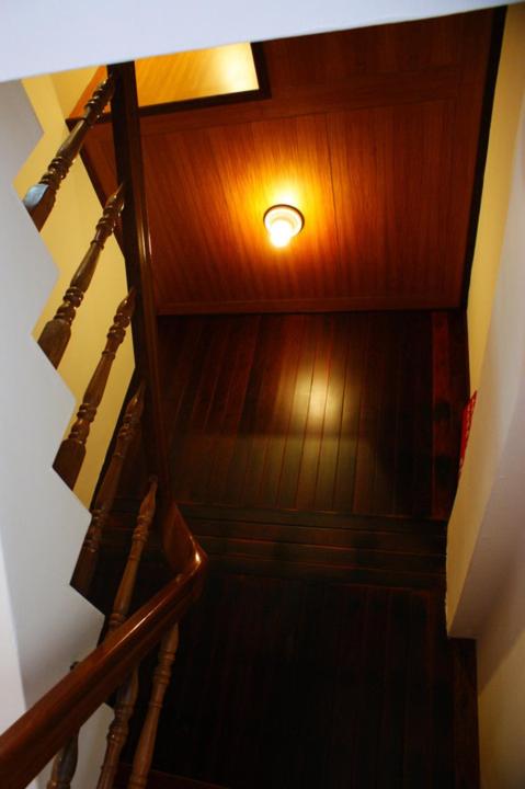 a wooden staircase with a light on the top at TopHome 9 in Jiufen