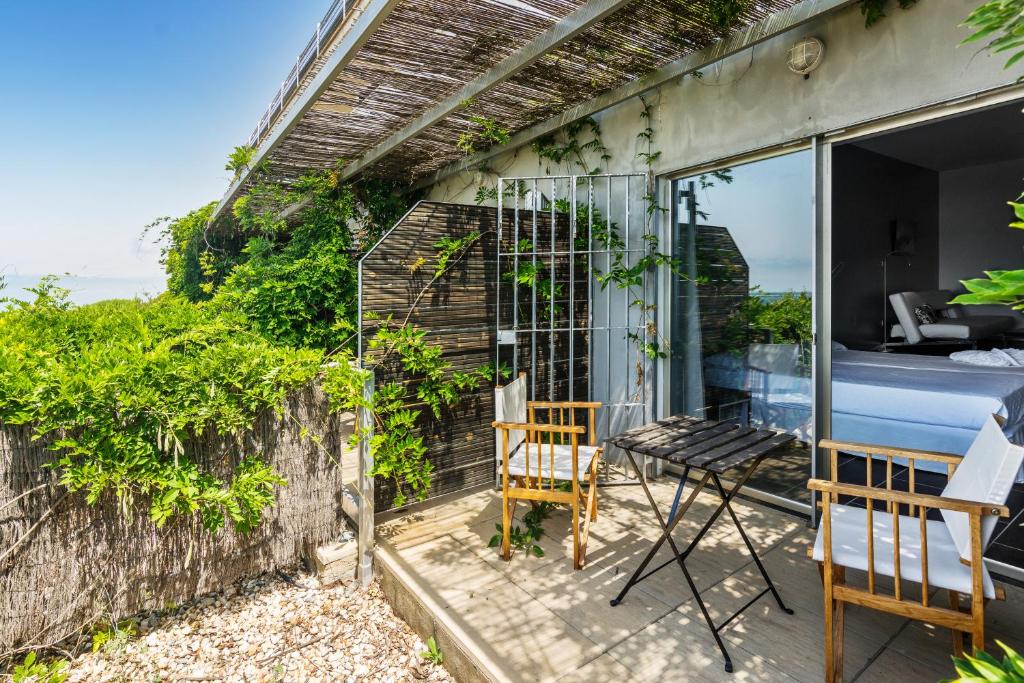 a room with a table and a chair on a balcony at Mazagonia in Mazagón