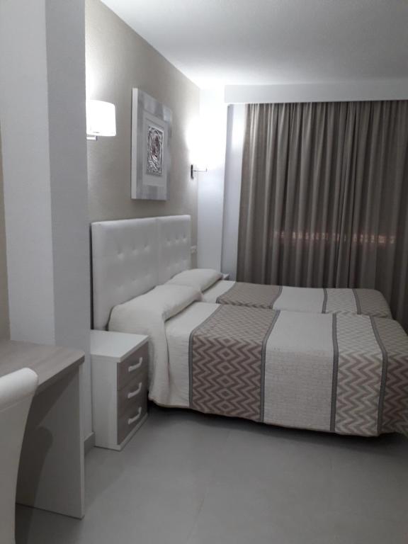 Postel nebo postele na pokoji v ubytování Hotel Goya