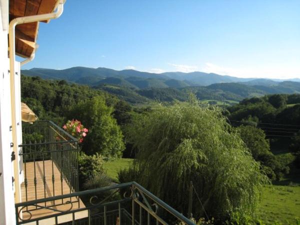 a balcony of a house with a view of the mountains at Lèdre in La Bastide-de-Sérou