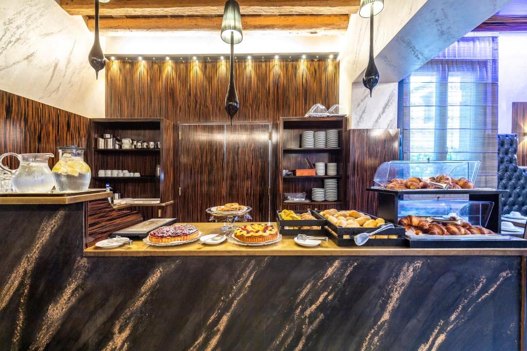 a buffet line with many different types of pastries at Hotel Abbazia in Venice
