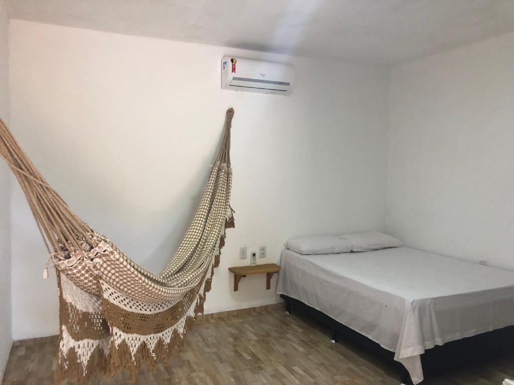 Un ou plusieurs lits dans un hébergement de l'établissement Flat Moitas - Sua casa na praia!