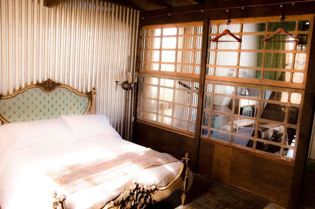 a bedroom with a bed and a window at El Granero in Sierra de los Padres