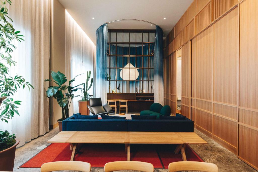 a living room with a blue couch and a table at Hotel K5 in Tokyo