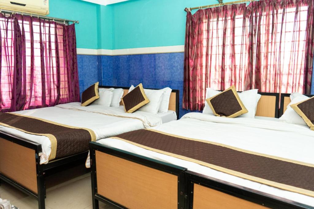 Postel nebo postele na pokoji v ubytování Tirupati Lodge NJP