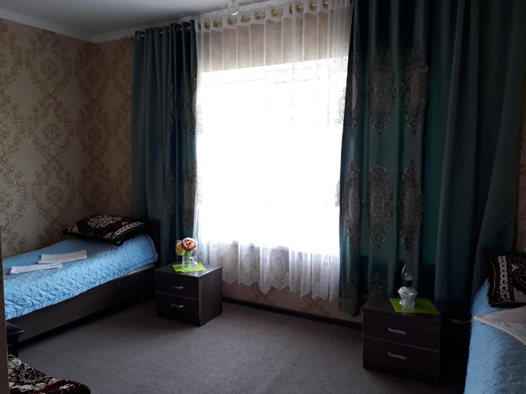 Postel nebo postele na pokoji v ubytování Guest House Jekshen
