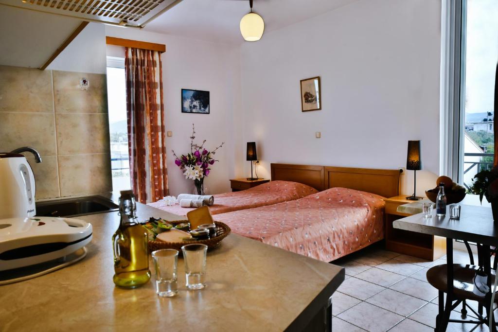 Nirevel Apartments في غوفي: غرفة نوم بسرير وطاولة عليها نظارة