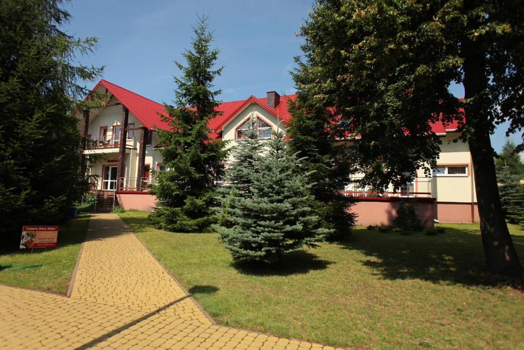 una casa con un árbol de Navidad en el patio en Hotel Nad Mrogą, en Koluszki