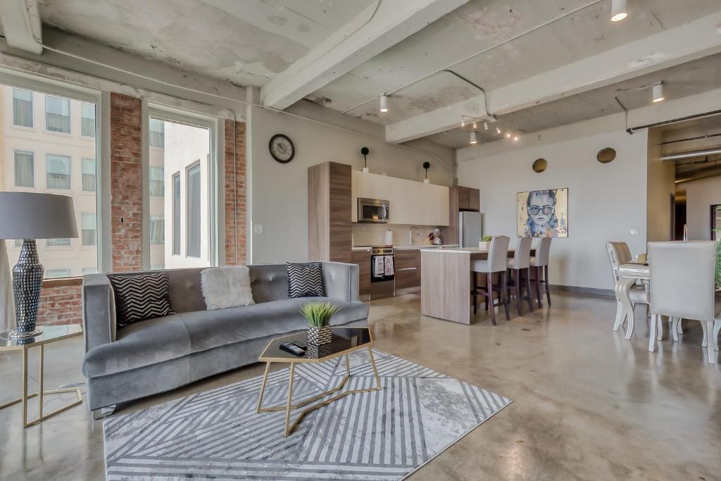 a living room with a couch and a table at Luxury Downtown Dallas Stay by Amyfinehouse in Dallas