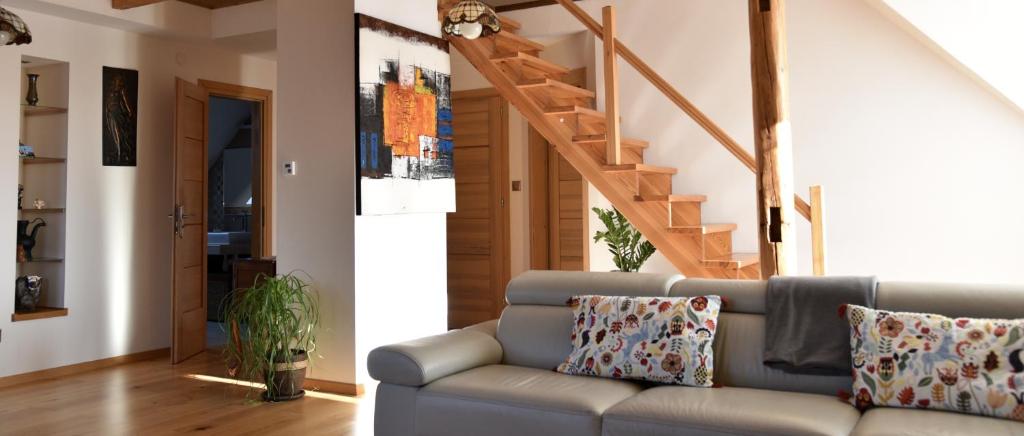 a living room with a couch and a staircase at VIP apartment in Mogilany close to Kraków Air con WLAN Highspeed in Mogilany