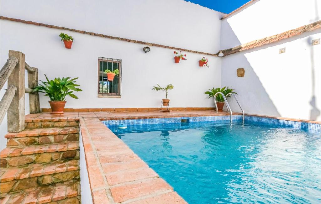 a swimming pool in the middle of a house at Pet Friendly Home In Hornachuelos With Kitchen in Hornachuelos