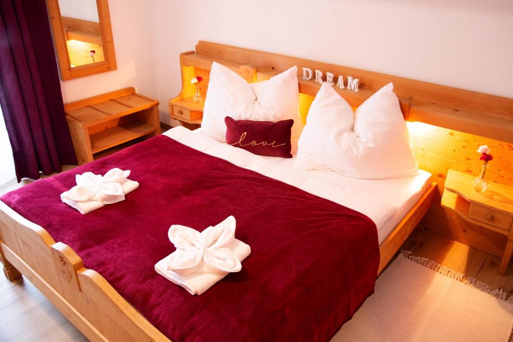 a bedroom with a large bed with bows on it at Apartments Marie B in Hallstatt