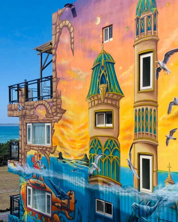 a mural painted on the side of a building at LoveSea 126 Beach Inn in Kenting