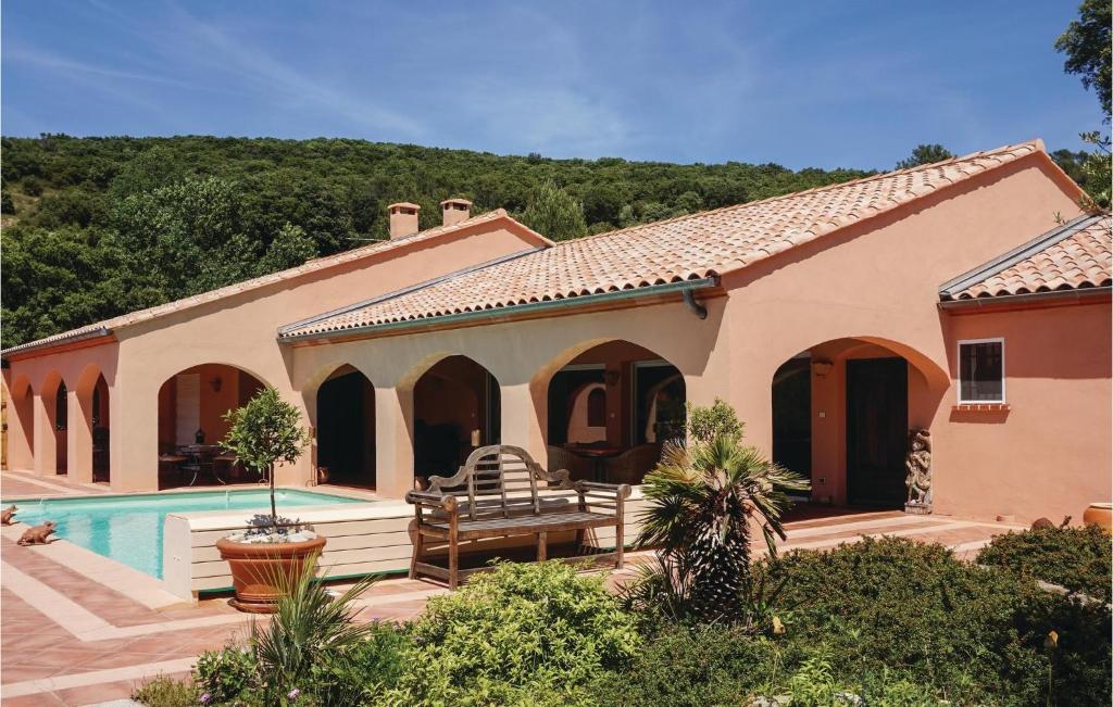 a villa with a swimming pool and a house at Beautiful Home In Pierrerue in Pierrerue