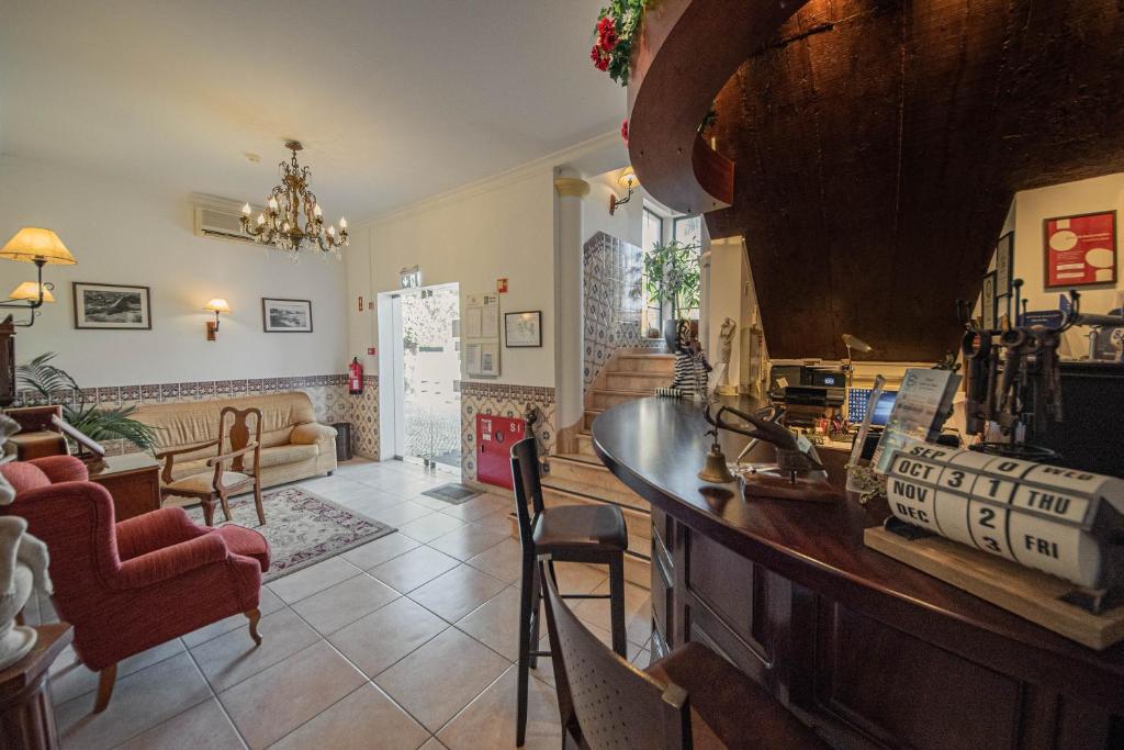 a large living room with a counter and chairs at Solar de Mos in Lagos