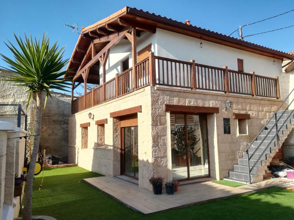 a house with a balcony on top of it at Casa Ecoeficiente Eguzkilore in Torrelles