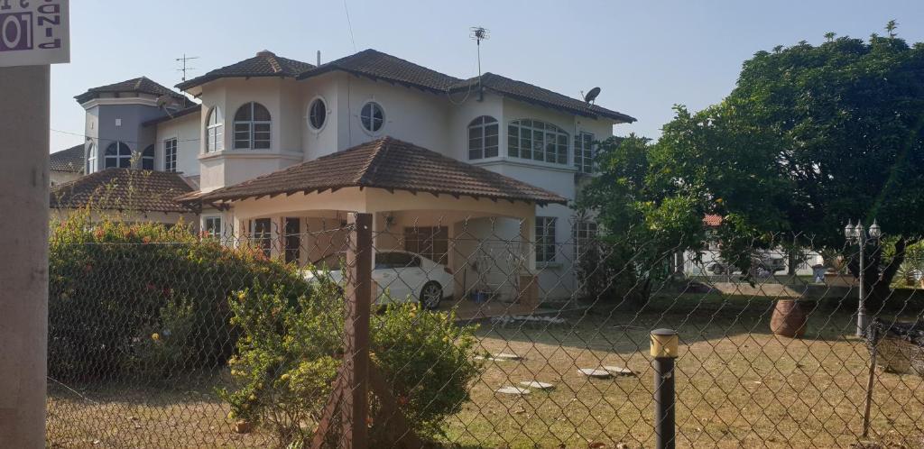 a house with a fence in front of it at Al-Bayt Homestay in Ayer Keroh