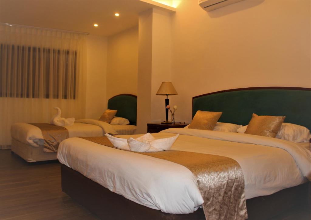 Postel nebo postele na pokoji v ubytování New MerryLand Hotel