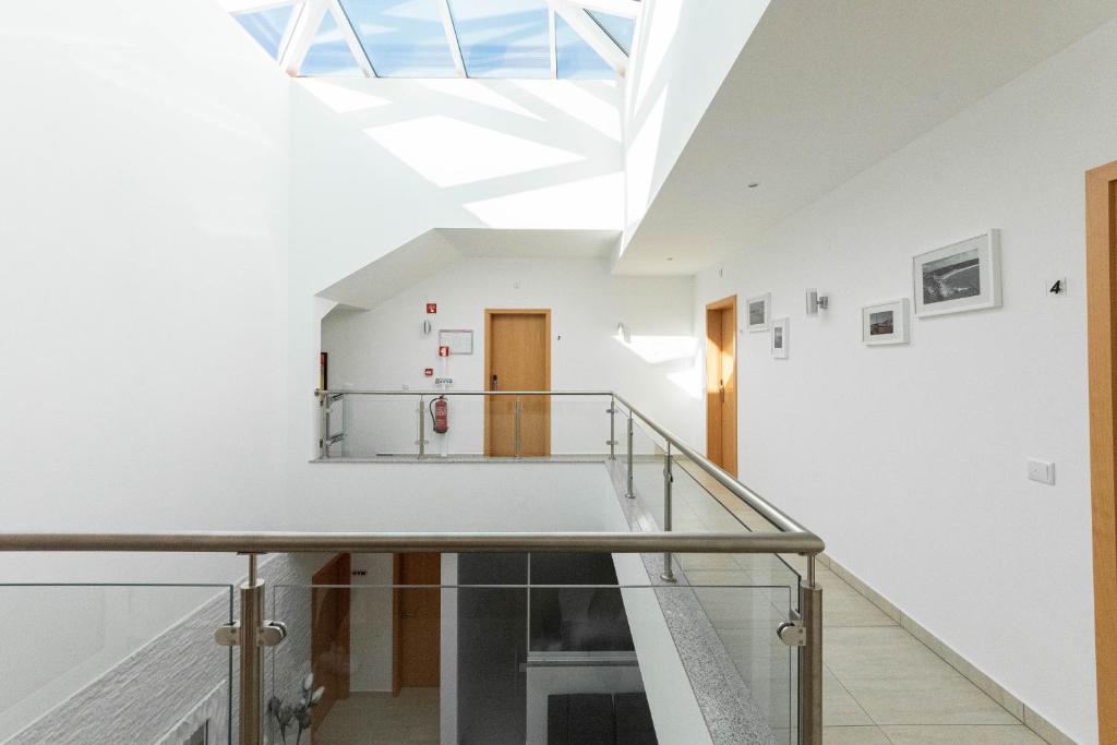 a staircase in a white room with a skylight at Solar de Mos in Lagos